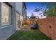 Backyard with comfortable seating, privacy wall, and exterior lighting at 11315 Gravitation Dr, Las Vegas, NV 89135