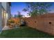 Cozy backyard with comfortable seating, privacy wall, and mature landscaping at 11315 Gravitation Dr, Las Vegas, NV 89135