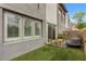 Backyard with artificial grass, comfortable seating and view of the modern home at 11315 Gravitation Dr, Las Vegas, NV 89135