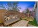 Relaxing backyard featuring modern seating, an outdoor lounge chair, a small wood coffee table, and manicured lawn at 11315 Gravitation Dr, Las Vegas, NV 89135