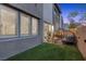 Cozy backyard with artificial grass, comfortable seating and view of the modern home at 11315 Gravitation Dr, Las Vegas, NV 89135