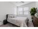 Bright bedroom with modern decor, cozy bed, and a large window with blinds at 11315 Gravitation Dr, Las Vegas, NV 89135