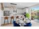 Bright dining area featuring a pendant light fixture, seating for four, and kitchen island at 11315 Gravitation Dr, Las Vegas, NV 89135