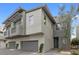 Contemporary townhome featuring gray exterior, private balcony with awning, and an attached two-car garage at 11315 Gravitation Dr, Las Vegas, NV 89135