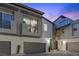 Contemporary two-story townhome featuring a private balcony, gray exterior paint, and two-car garage at 11315 Gravitation Dr, Las Vegas, NV 89135