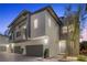 Modern two-story townhome featuring a two-car garage and contemporary architectural details at 11315 Gravitation Dr, Las Vegas, NV 89135