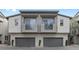 Stylish townhome features gray exterior, two balconies with awnings, and an attached two-car garage at 11315 Gravitation Dr, Las Vegas, NV 89135