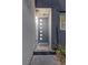 Modern home exterior with a stylish front door and stone walkway at 11315 Gravitation Dr, Las Vegas, NV 89135