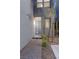 Front door with modern sidelights and hardware surrounded by rock landscaping and walkway at 11315 Gravitation Dr, Las Vegas, NV 89135