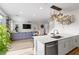 Open concept kitchen with stainless appliances and breakfast bar overlooking the living spaces at 11315 Gravitation Dr, Las Vegas, NV 89135
