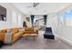Bright living room with modern decor, tan leather couch, and open floor plan at 11315 Gravitation Dr, Las Vegas, NV 89135