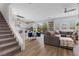 Open concept living space with a staircase, kitchen, dining area, and living room at 11315 Gravitation Dr, Las Vegas, NV 89135