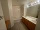Bathroom with a tub, shower, double sink vanity, and modern lighting at 15 E Agate Ave # 202, Las Vegas, NV 89123