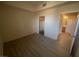 A vacant bedroom with wood-look floors adjacent to the bathroom and closet at 15 E Agate Ave # 202, Las Vegas, NV 89123