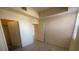 Bright bedroom features a closet, light hardwood floors, and a neutral color palette at 15 E Agate Ave # 202, Las Vegas, NV 89123