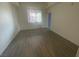 Bright bedroom with wood-look floors, window view, and access to a private bathroom at 15 E Agate Ave # 202, Las Vegas, NV 89123