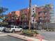 Condominium complex with well-maintained landscaping and palm trees on a clear, sunny day at 15 E Agate Ave # 202, Las Vegas, NV 89123