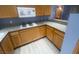 Kitchen features modern appliances, wooden cabinets, and ample granite counter space at 15 E Agate Ave # 202, Las Vegas, NV 89123