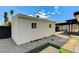 The stucco back house has two awning windows and a gravel surround at 1660 Izabella Ave, Las Vegas, NV 89169