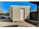 The stucco back house has a white door and a surrounding gravel bed at 1660 Izabella Ave, Las Vegas, NV 89169