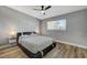 Comfortable bedroom with a ceiling fan, a window with blinds, and wood-look flooring at 1660 Izabella Ave, Las Vegas, NV 89169