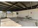 Open carport with concrete flooring and utility access points on the wall at 1660 Izabella Ave, Las Vegas, NV 89169