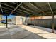 Open carport with concrete flooring leading to a detached unit in backyard at 1660 Izabella Ave, Las Vegas, NV 89169