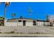 Single-story home with desert landscaping, secure gated entrance, and a private driveway at 1660 Izabella Ave, Las Vegas, NV 89169