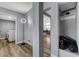 The hall features a modern light, grey walls, and a look at the kitchen and laundry room at 1660 Izabella Ave, Las Vegas, NV 89169
