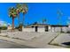 Exterior view showcasing a single-story home with palm trees and desert landscaping at 1660 Izabella Ave, Las Vegas, NV 89169