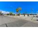 Street view of single-story home with palm trees, desert landscaping, and ample parking at 1660 Izabella Ave, Las Vegas, NV 89169