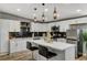 Bright kitchen featuring white cabinets, quartz countertops, black backsplash, and stainless steel appliances at 1660 Izabella Ave, Las Vegas, NV 89169