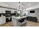 Open-concept kitchen featuring an island with barstool seating seamlessly connected to the living area at 1660 Izabella Ave, Las Vegas, NV 89169