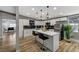 Bright kitchen featuring white cabinets, quartz countertops, a black backsplash, and stainless steel appliances at 1660 Izabella Ave, Las Vegas, NV 89169