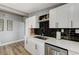 Modern kitchen featuring white cabinets, stainless steel appliances, and a stylish black backsplash at 1660 Izabella Ave, Las Vegas, NV 89169
