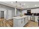Modern kitchen island featuring a quartz countertop, white cabinetry, and stylish pendant lighting at 1660 Izabella Ave, Las Vegas, NV 89169