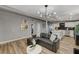 Stylish living room with open concept design including modern furniture, lighting, and kitchen view at 1660 Izabella Ave, Las Vegas, NV 89169