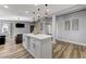 Contemporary open living space features a kitchen island, hard surface floors, and modern lighting at 1660 Izabella Ave, Las Vegas, NV 89169