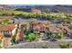 Aerial view of a luxury home with a terracotta roof and a meticulously manicured yard at 1795 Anelli Ct, Henderson, NV 89012