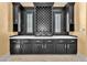 Elegant bar area with dark cabinets, drawers, and light colored countertops at 1795 Anelli Ct, Henderson, NV 89012