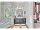 Elegant bathroom with a glass shower, modern vanity, decorative mirror, and tiled floor at 1795 Anelli Ct, Henderson, NV 89012