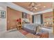 Comfortable bedroom featuring a ceiling fan, decorative rug, and ample natural light at 1795 Anelli Ct, Henderson, NV 89012