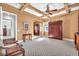 Bright bedroom with trey ceilings, warm paint, and hardwood floors at 1795 Anelli Ct, Henderson, NV 89012
