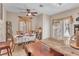 Bright dining area featuring a ceiling fan, a decorative table setting, and a corner cabinet at 1795 Anelli Ct, Henderson, NV 89012