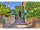 Stone paver path to front door framed with manicured landscaping and stone planter boxes at 1795 Anelli Ct, Henderson, NV 89012