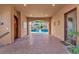 Elegant entryway leading to an outdoor pool area featuring brick flooring and ambient lighting at 1795 Anelli Ct, Henderson, NV 89012