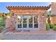 Exterior view of cabana featuring a brick facade, a tiled roof, and sliding glass doors at 1795 Anelli Ct, Henderson, NV 89012