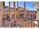 Spacious property with a courtyard featuring tall palm trees, and multiple balconies offering scenic views at 1795 Anelli Ct, Henderson, NV 89012