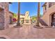 The inviting courtyard showcases a decorative fireplace feature and lush landscaping at 1795 Anelli Ct, Henderson, NV 89012