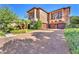 A beautiful stone home featuring manicured landscaping, 2nd story balconies, and a three car garage at 1795 Anelli Ct, Henderson, NV 89012